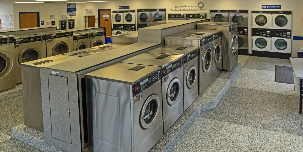 Showing rows of shiny, stainless steel washers and dryers.